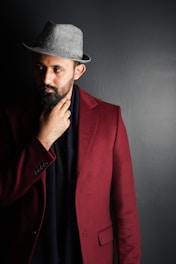 man in red suit jacket wearing black fedora hat