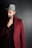 man in red suit jacket wearing black fedora hat