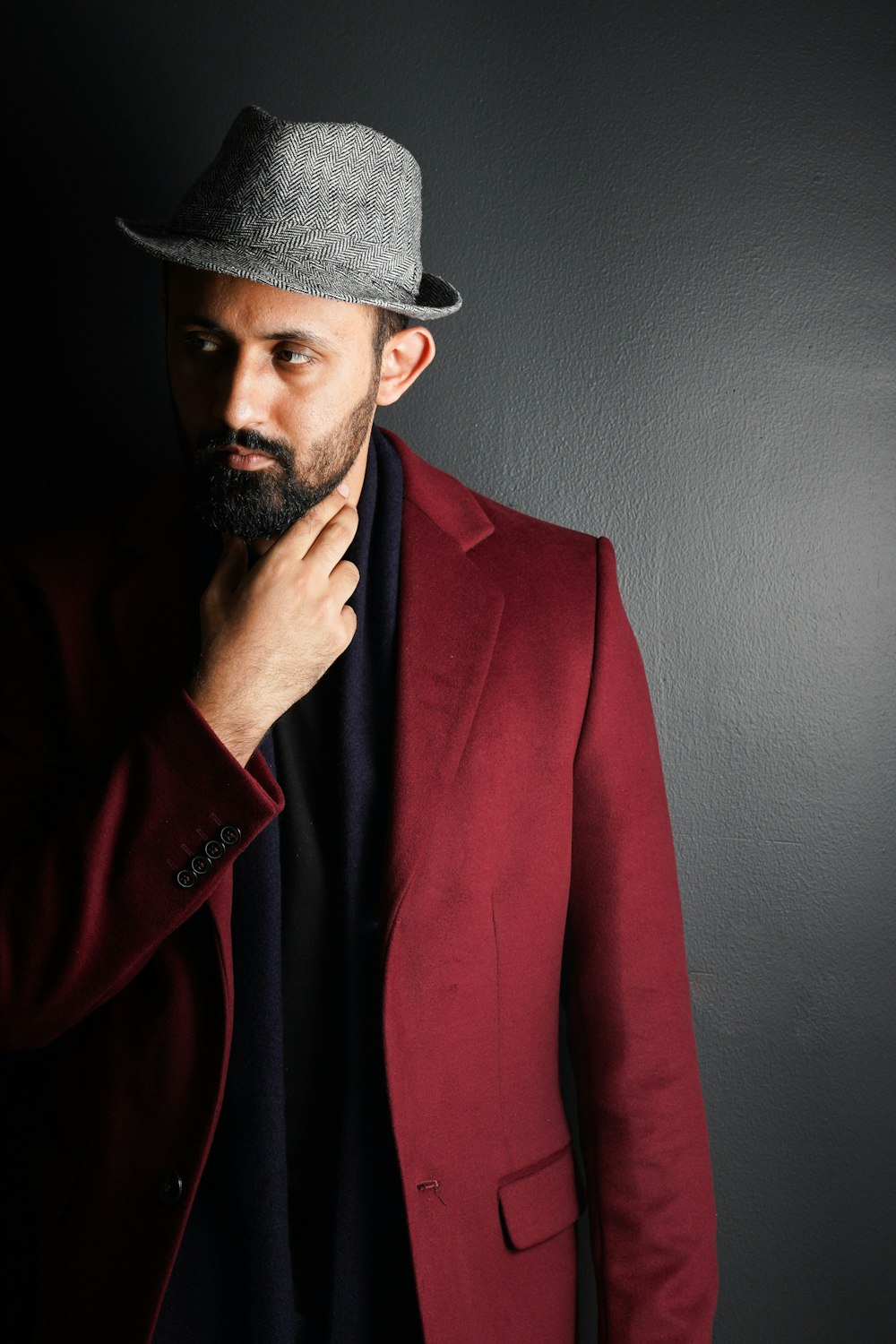 man in red suit jacket wearing black fedora hat