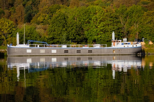 white and blue boat on water in Boulogne-Billancourt France