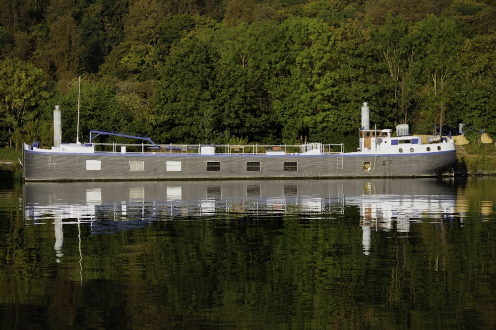 white and blue boat on water