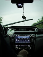 A car dashboard showing a satellite radio tuned to a station.
