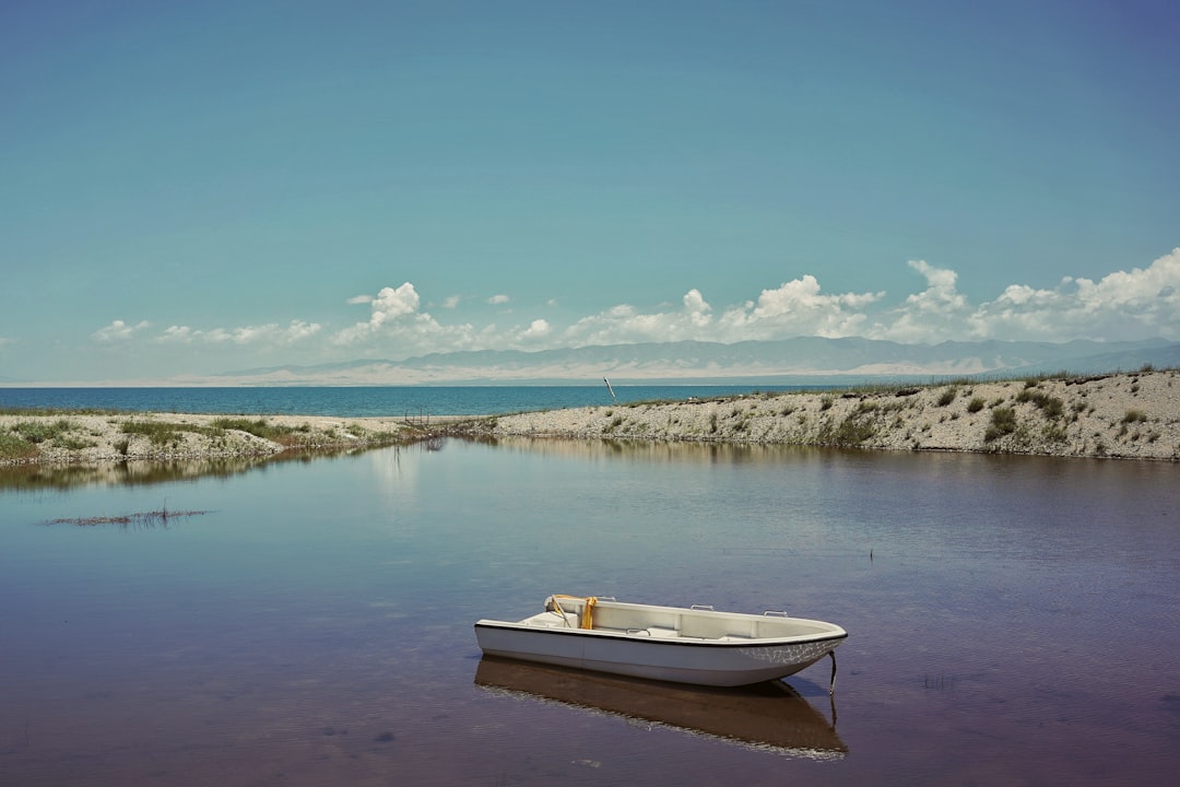 white boat on lake during daytime