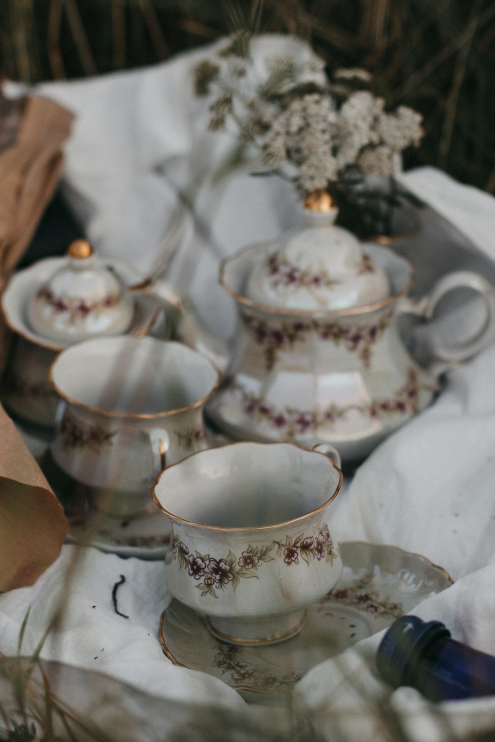 white and blue floral ceramic teacup