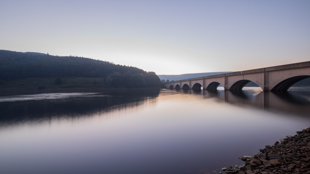 gray concrete bridge over river during daytime