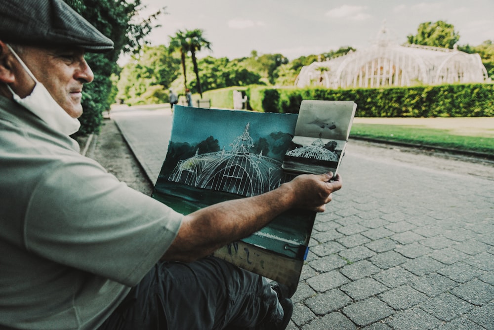 man in gray shirt reading newspaper