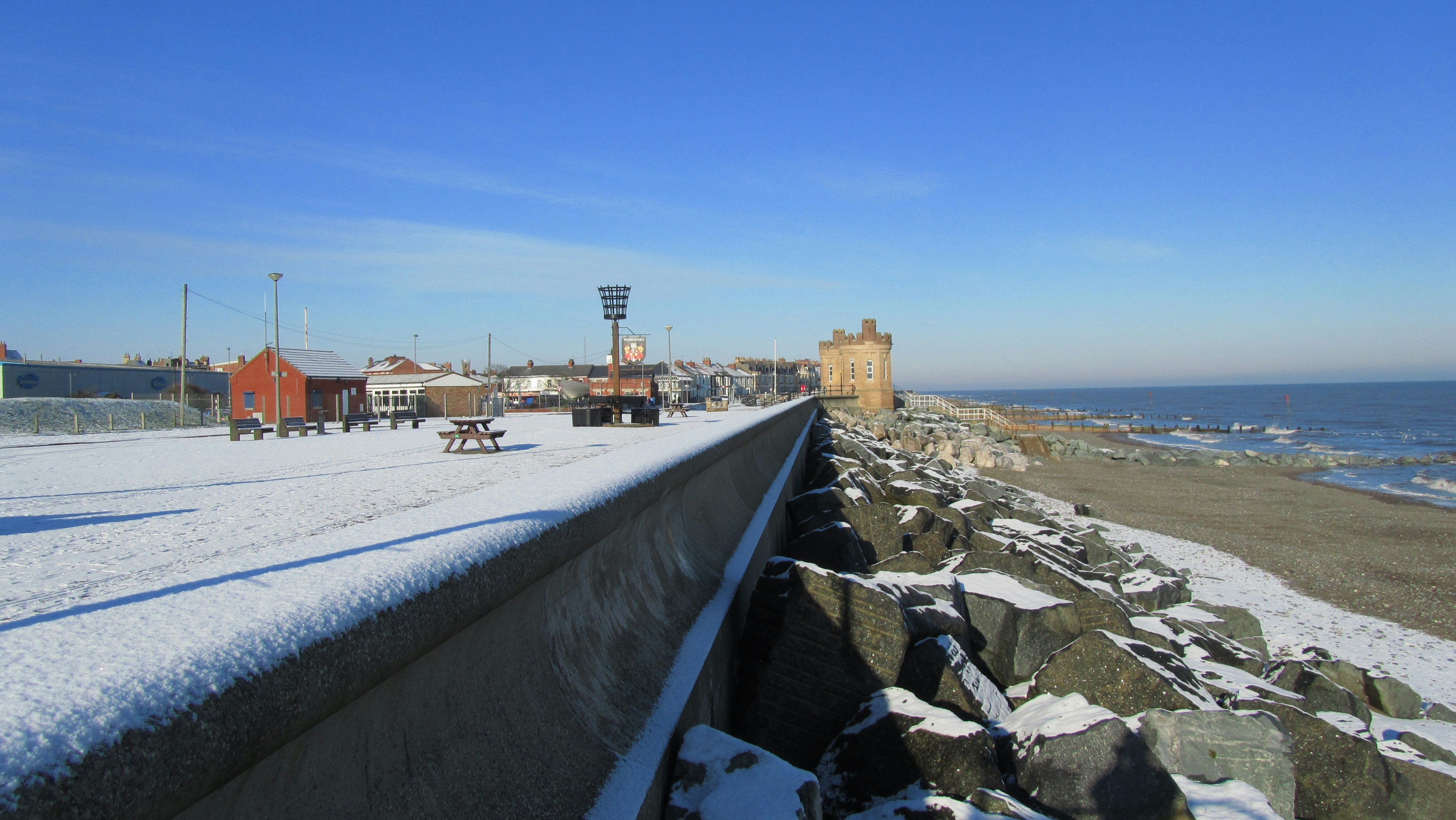 brown concrete building near body of water during daytime prom teams background