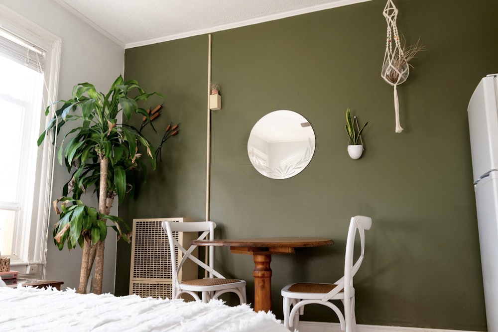 white and brown wooden chair beside green potted plant