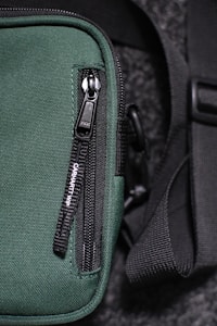 black and gray bag on green textile