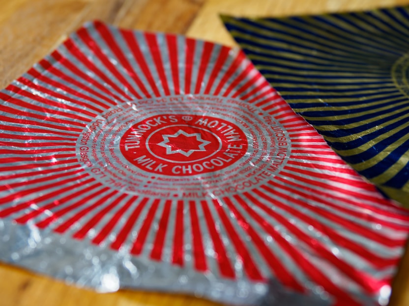 Close-up of soflux butter paper wrapping fresh bakery items with royal blue and gold accents