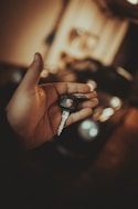 a person holding a car key in their hand