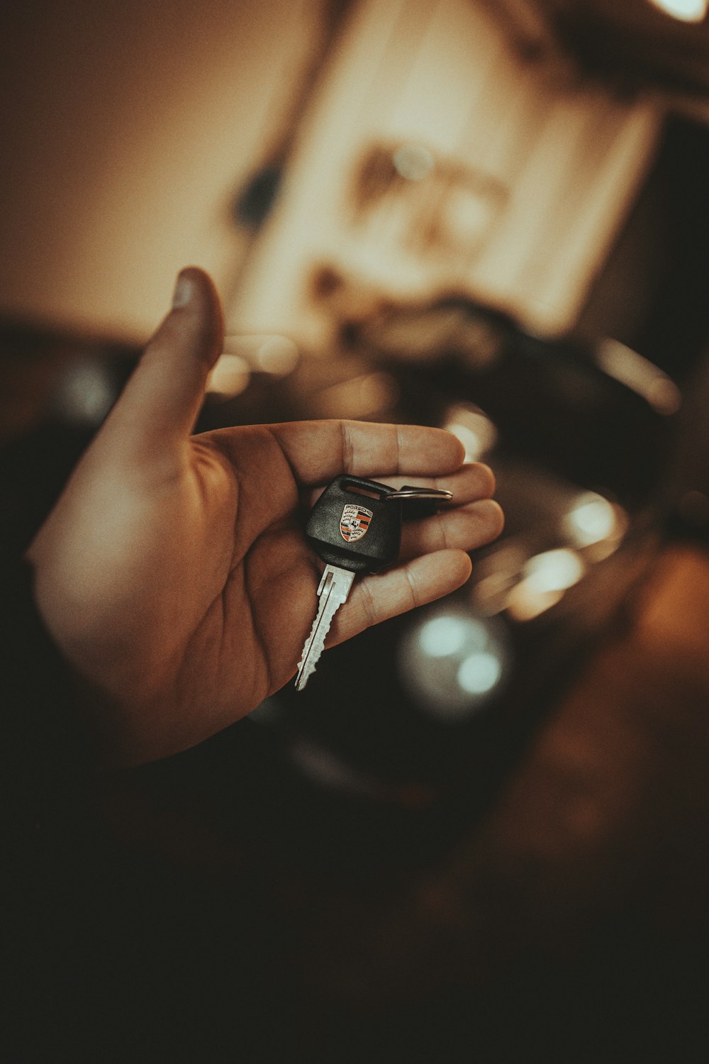 a person holding a car key in their hand