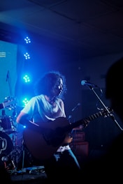 man playing guitar on stage