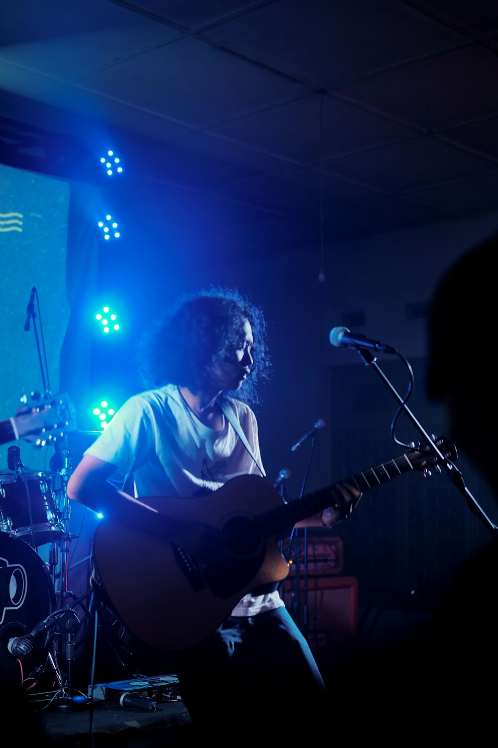 man playing guitar on stage