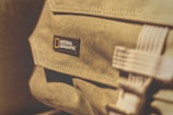 Close-up of the Bali Comfort Kit bag showcasing its elegant fabric and subtle logo embossing.