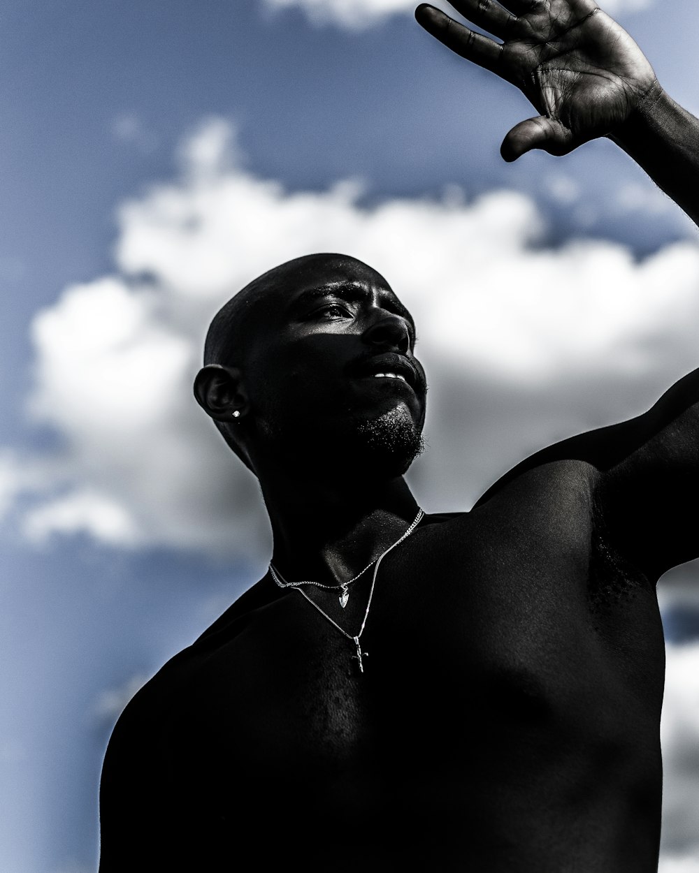 man in black shirt with silver necklace