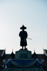 man in black coat statue