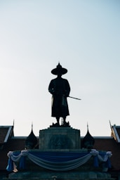man in black coat statue