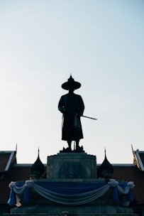 man in black coat statue