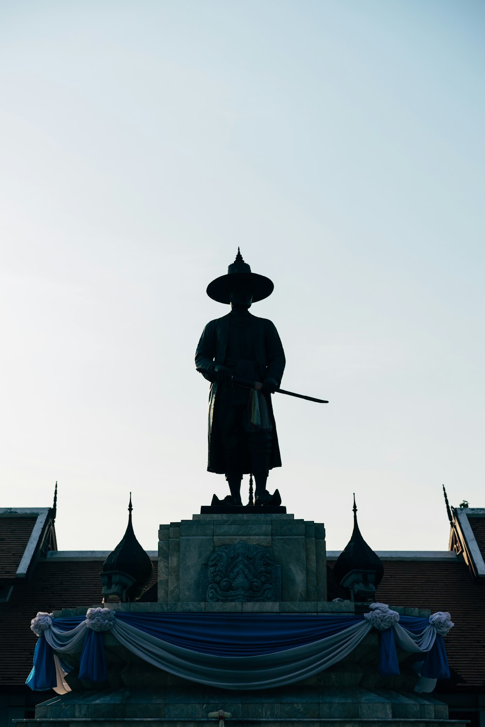 man in black coat statue