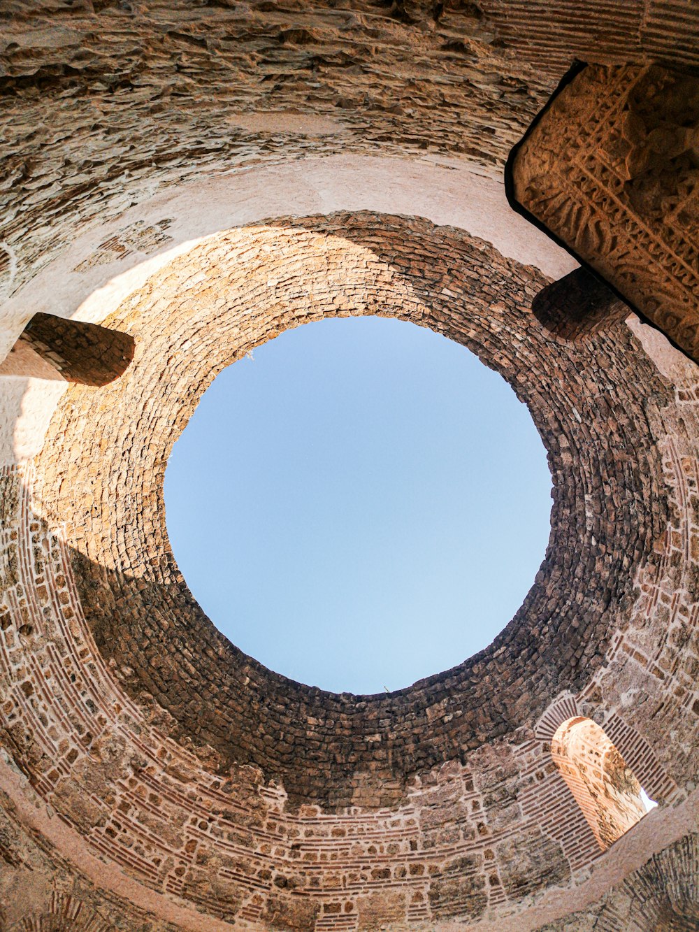 brown concrete hole under blue sky during daytime