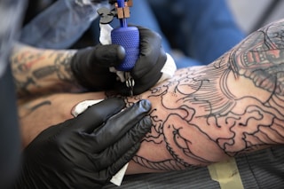person with tattoo on right arm