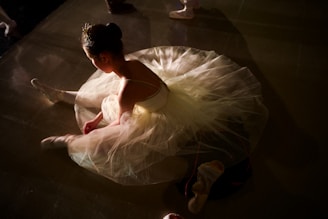 A ballerina performing a graceful arabesque in a minimalist studio with soft natural light.