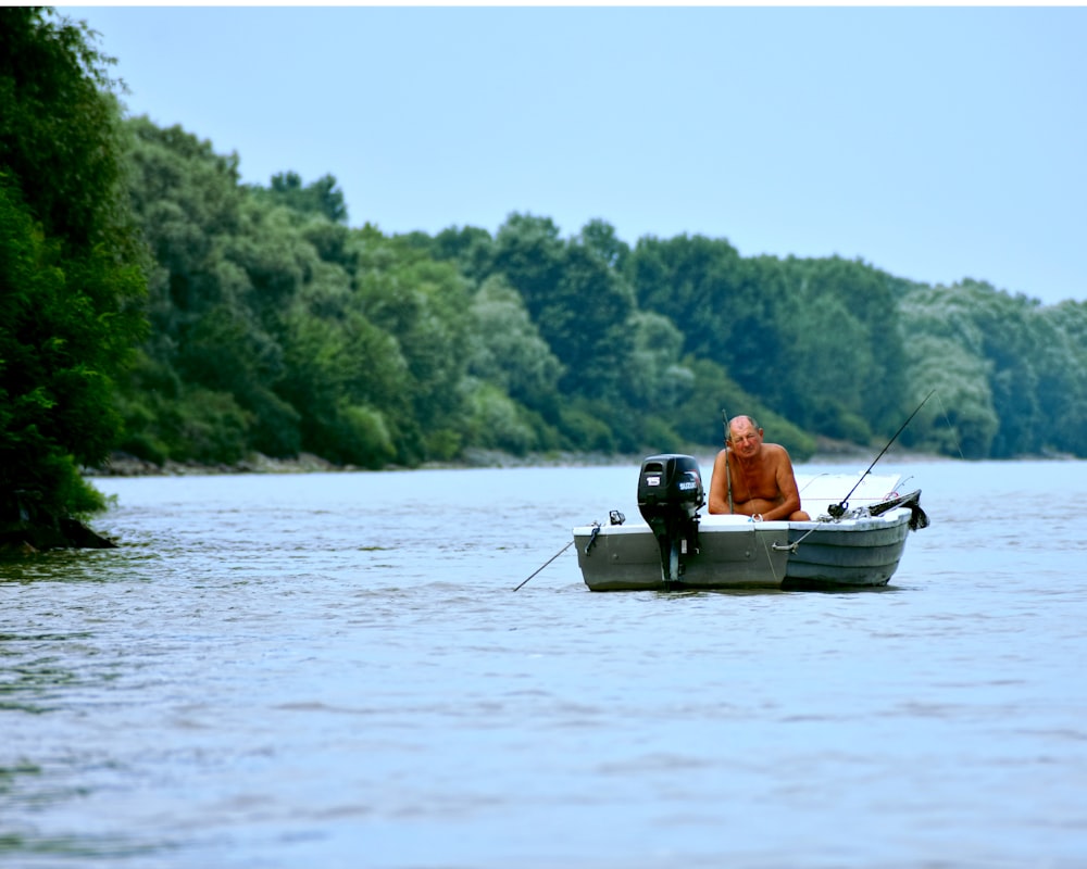 2 person riding on boat on lake during daytime