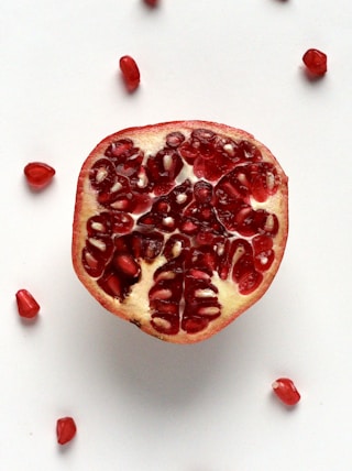 red sliced fruit on white surface