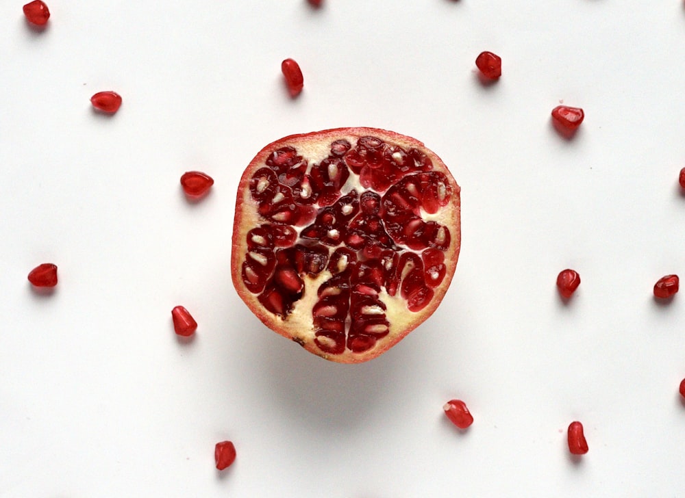 red sliced fruit on white surface