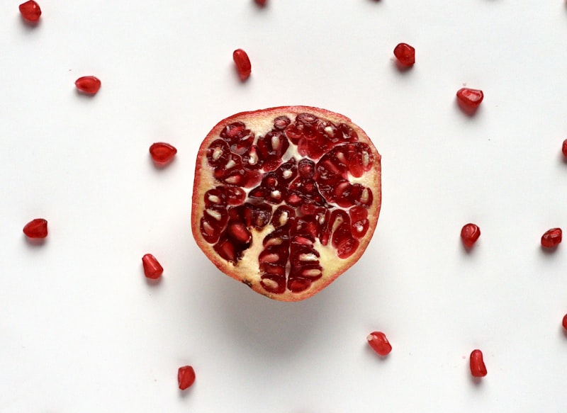 Fresh pomegranate arils on a wooden surface