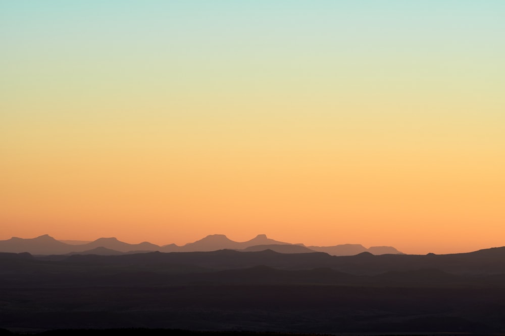 silhouette of mountains during sunset