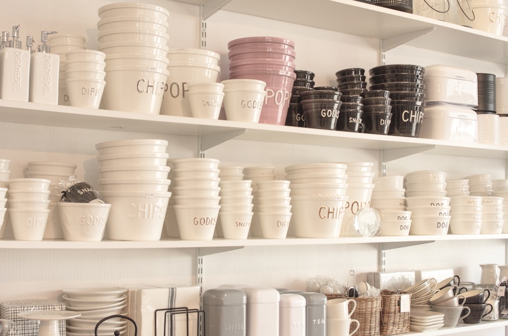 white plastic cups on white wooden shelf