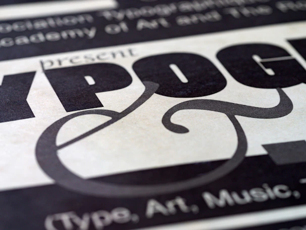 Close-up shot of a graphic design project featuring bold typography and dynamic shapes in a modern layout.