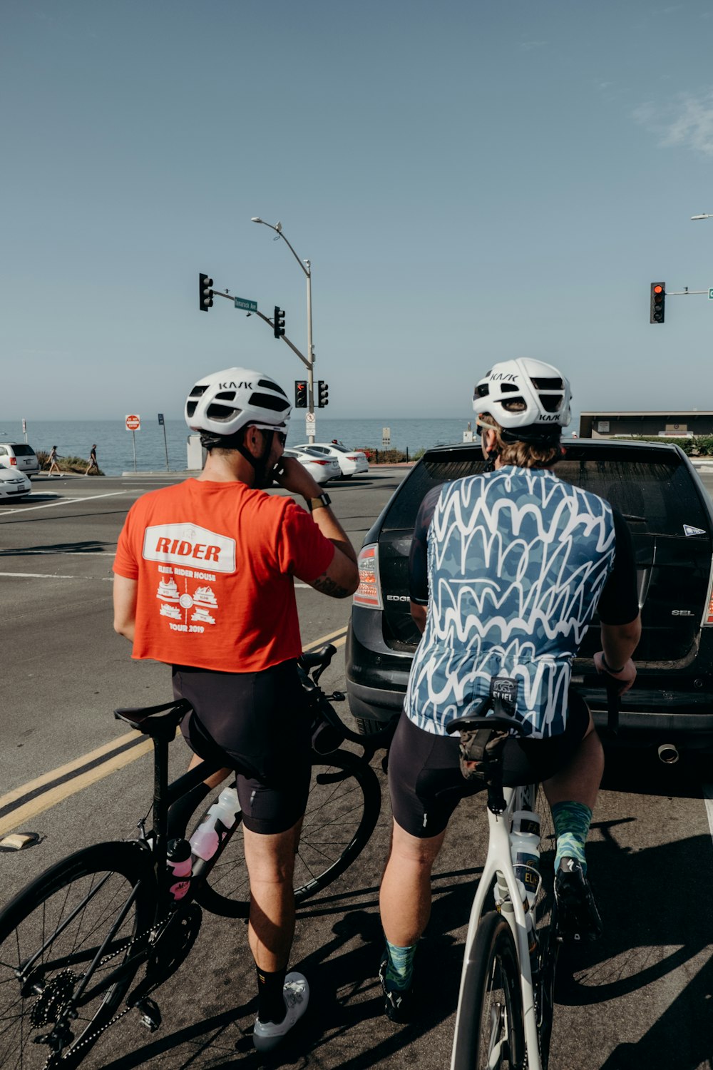 a couple of people riding bikes down a street