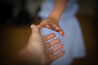 person holding babys hand