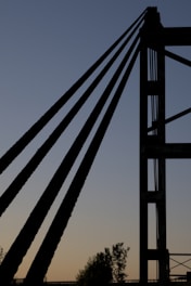 A minimalist, futuristic photo of the Rendsburg railway bridge at sunset, highlighting its steel structure.