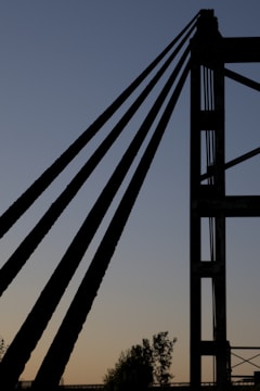 A minimalist, futuristic photo of the Rendsburg railway bridge at sunset, highlighting its steel structure.