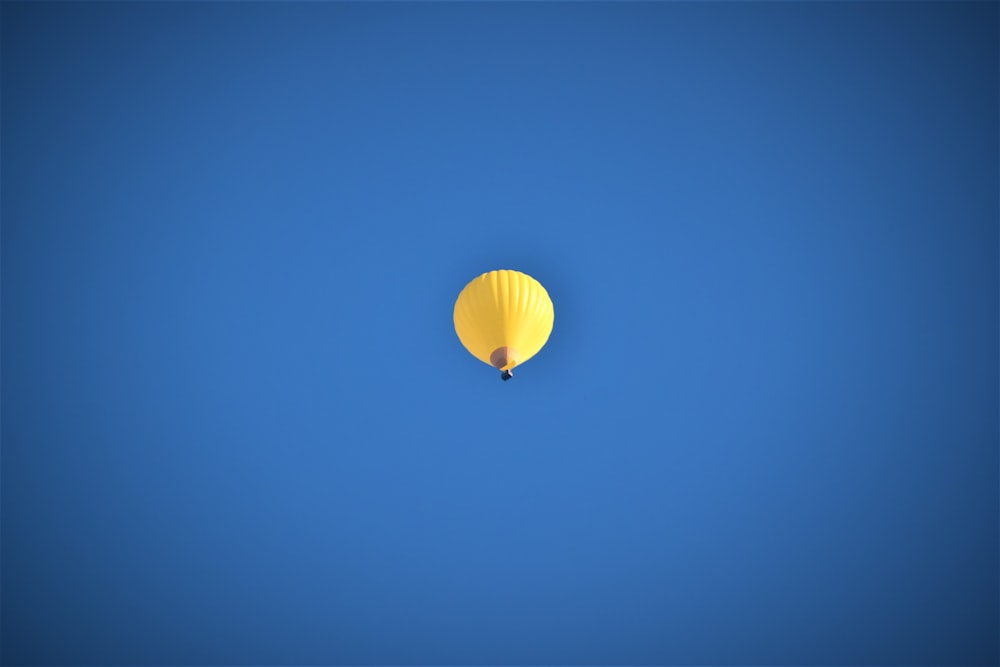 yellow balloon in blue sky
