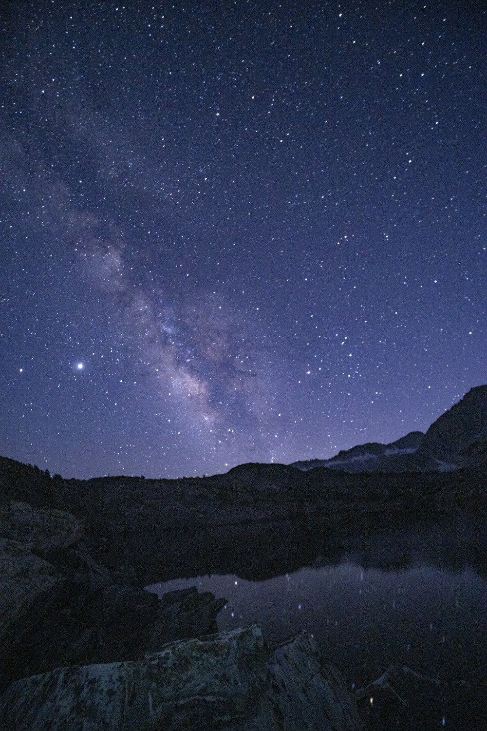 snow covered mountain under starry night