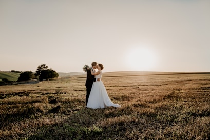 woman in white dress standing on green grass field during daytime