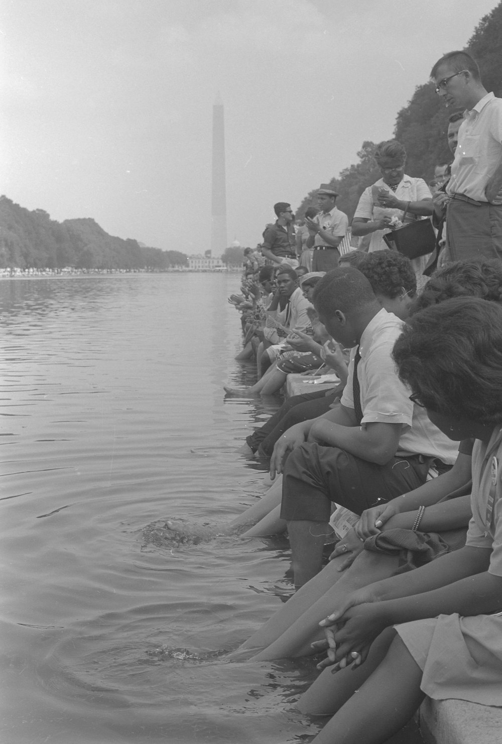 Demonstrators sit, with their feet in the Reflecting Pool, during the March on Washington