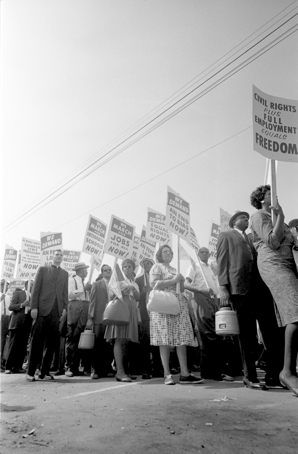 Demonstrators marching in the street holding signs during the March on Washington
