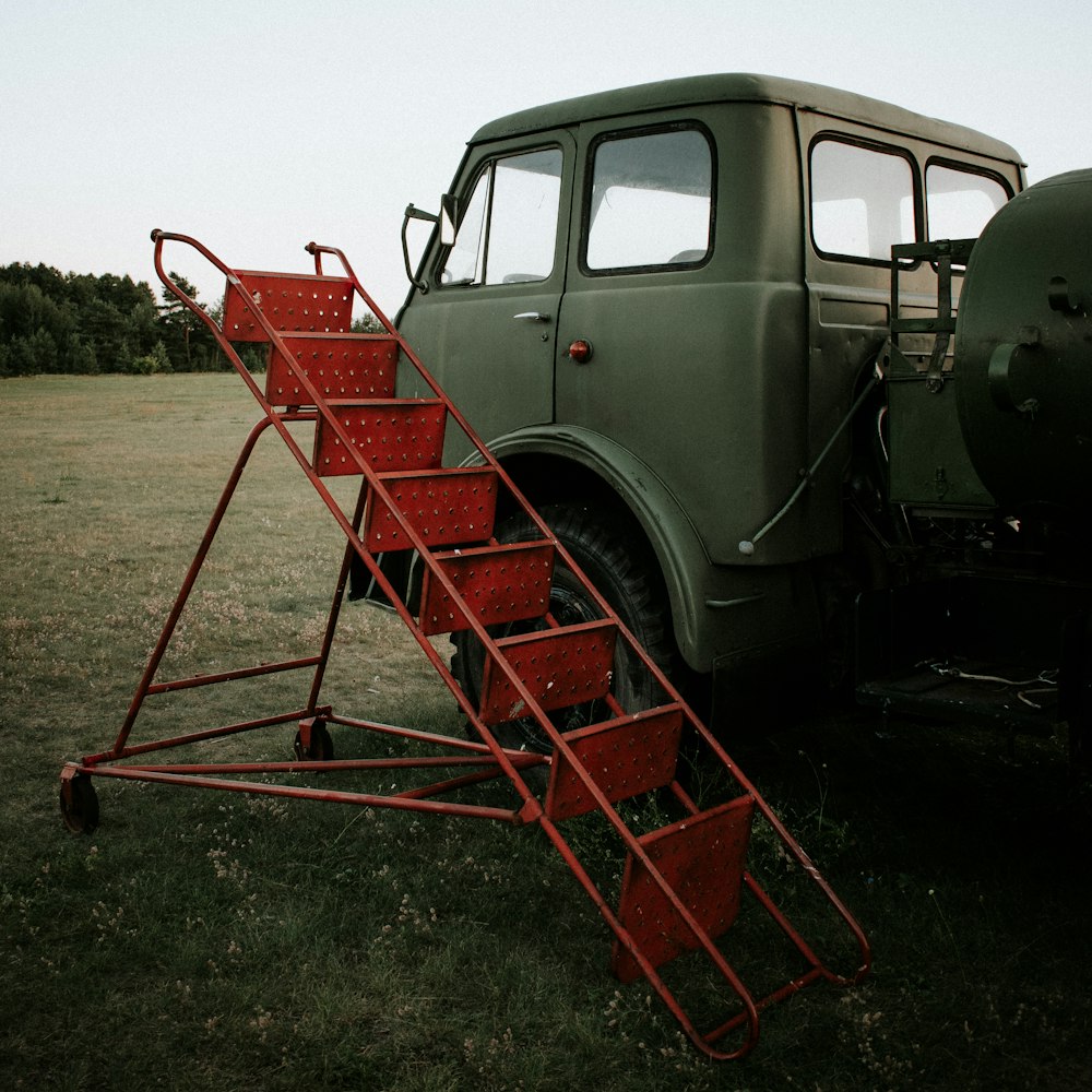 red and black utility trailer on brown field