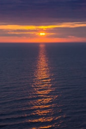 body of water during sunset