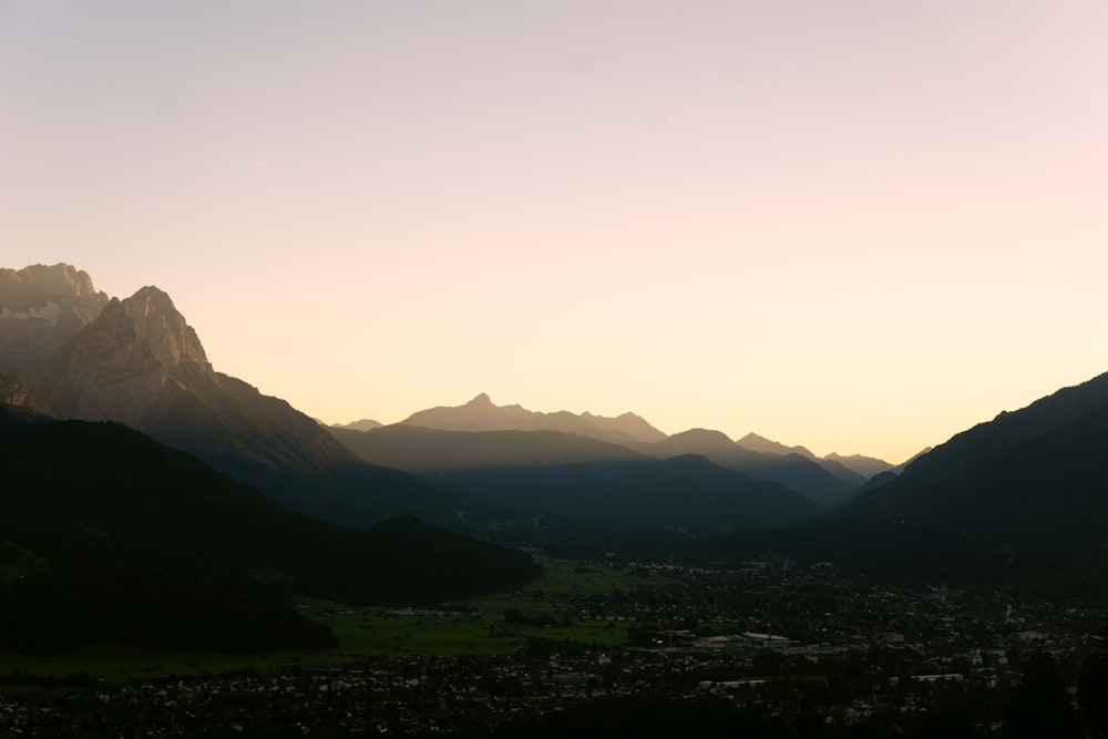 green grass field near mountains during daytime