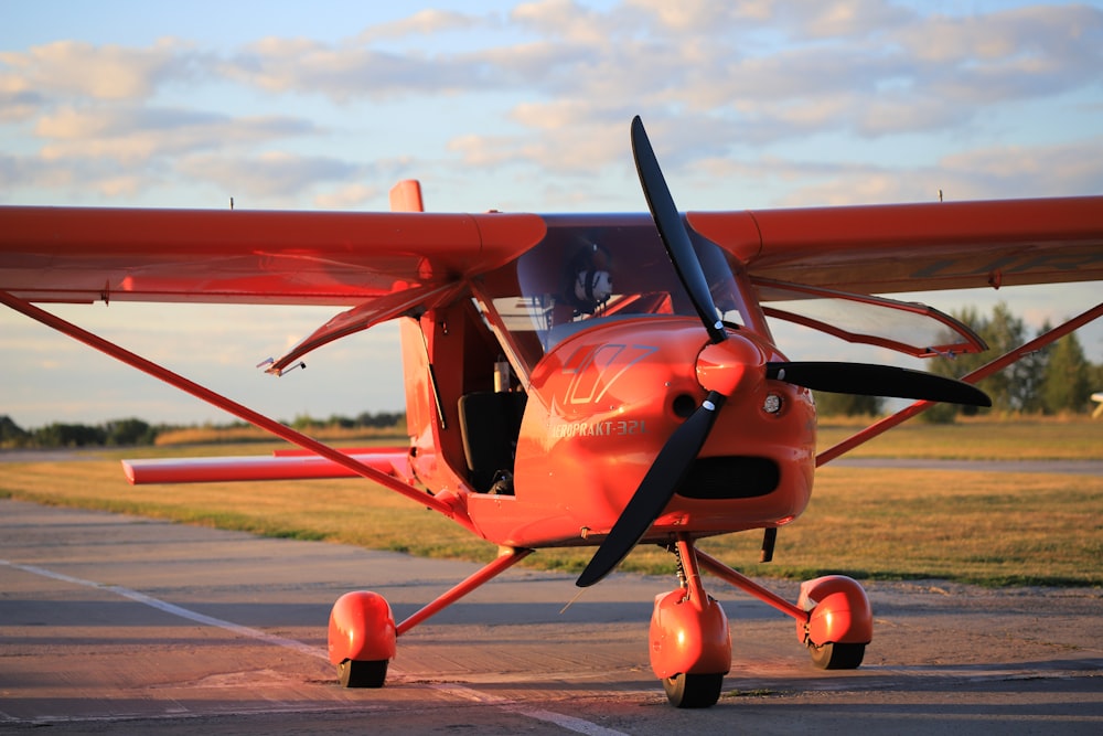 red and black plane on the ground