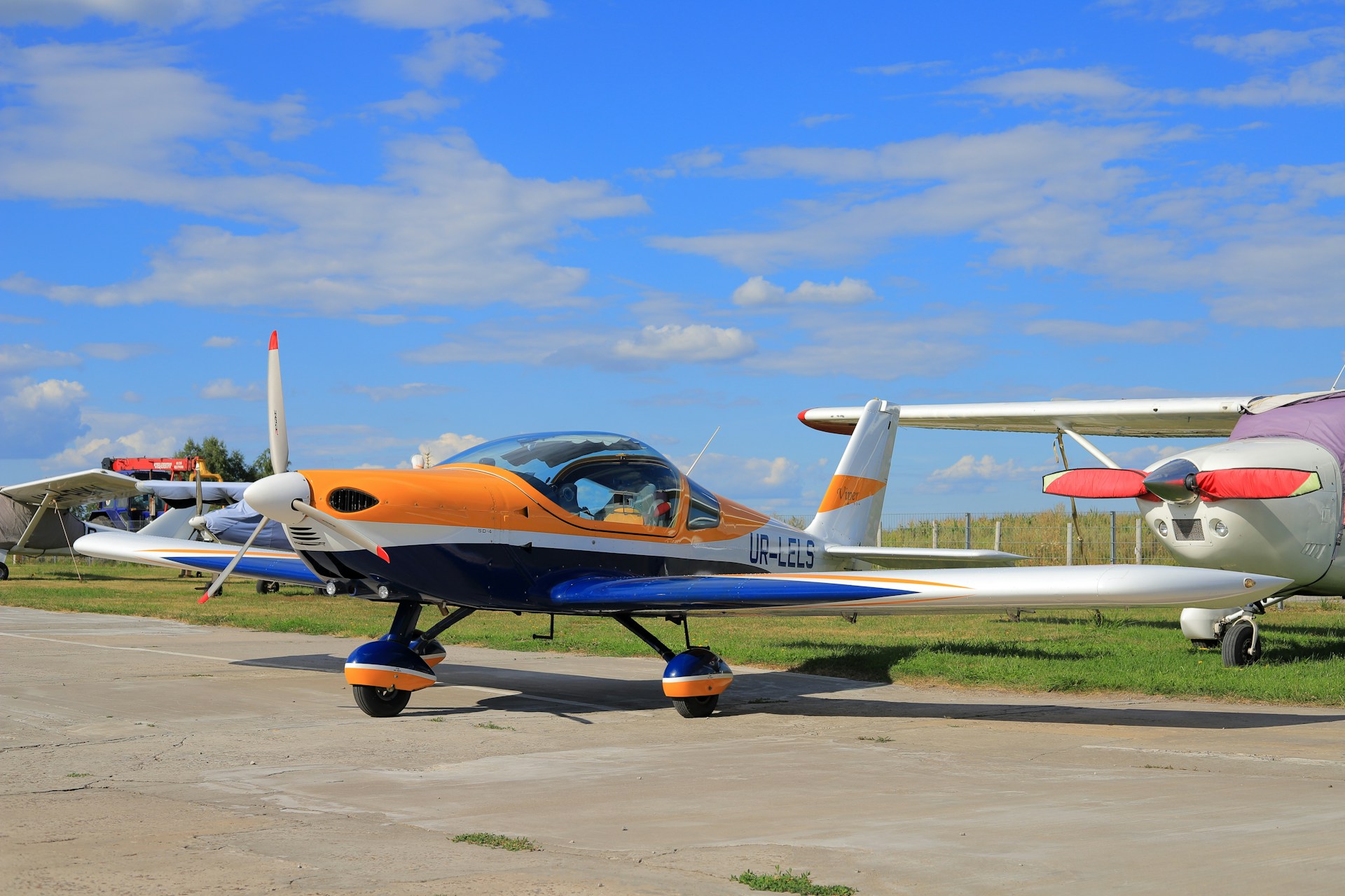 orange and white airplane under blue sky during daytime