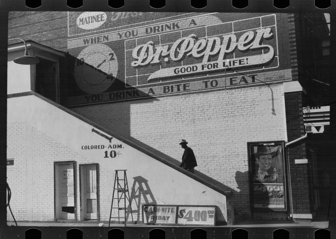 African American going in colored entrance of movie house