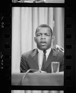 Professional man speaking at a conference podium.